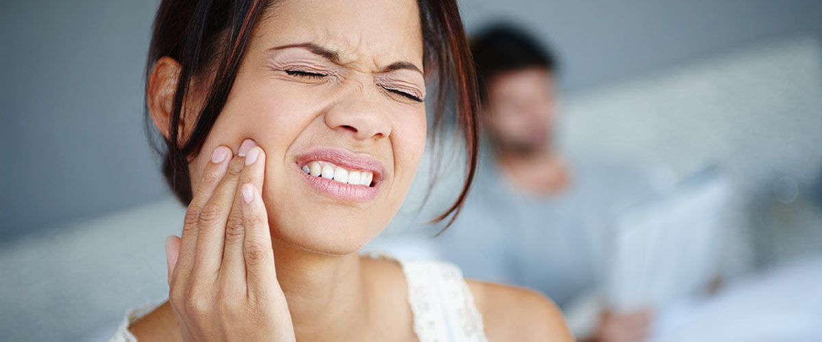 person with pain in their gums