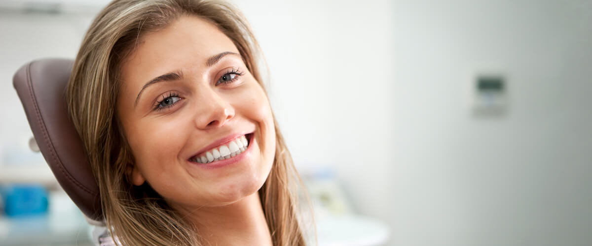 person smiling in dentists chair