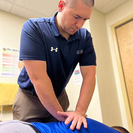 chiropractor adjusting patient's back