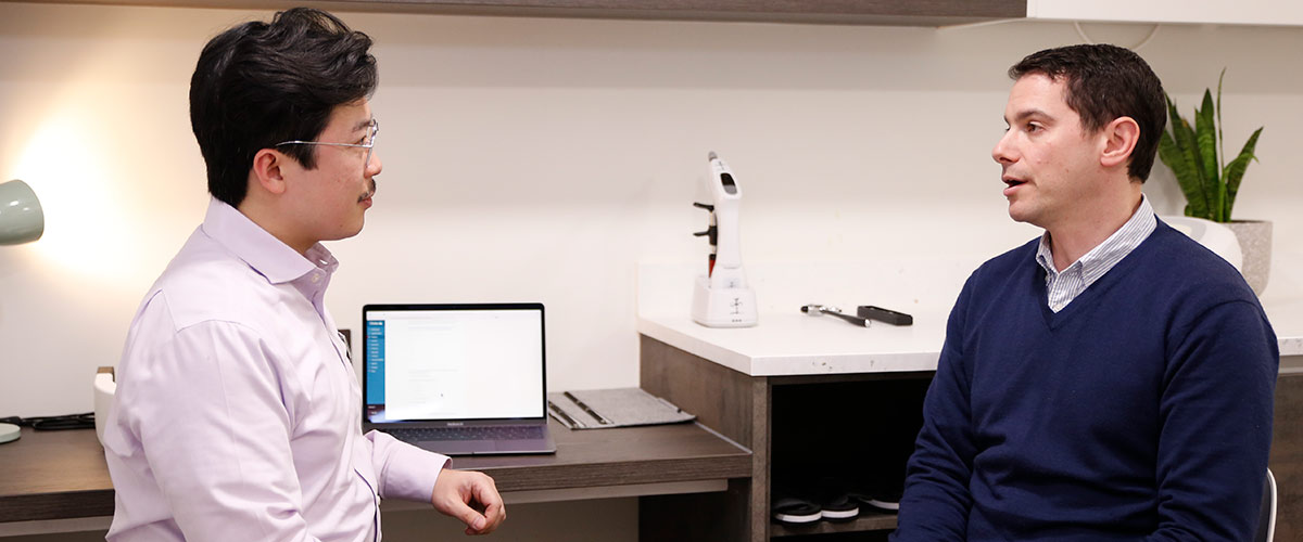 Dr Harvey and patient talking at desk