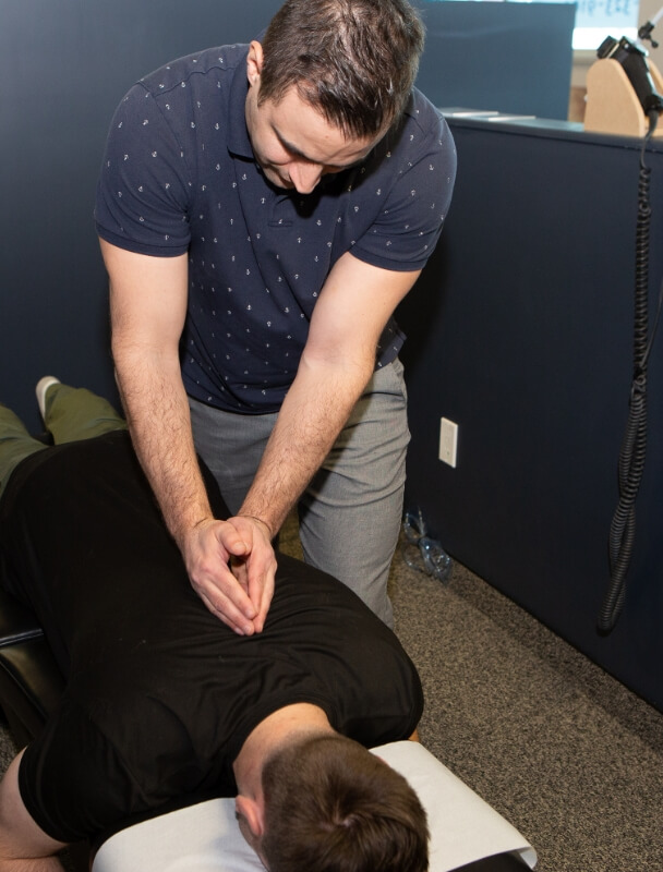 Dr. Peter adjusting a patient's back