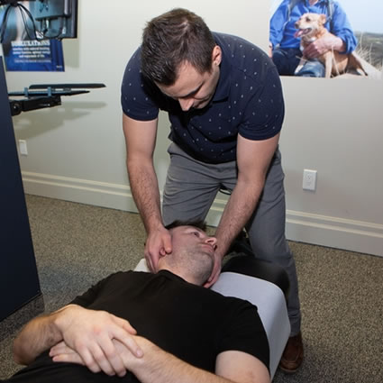 Dr. Peter adjusting a patient's neck