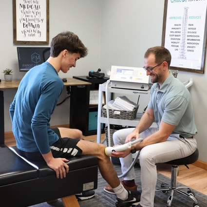 Dr Seth using Softwave on patients knee