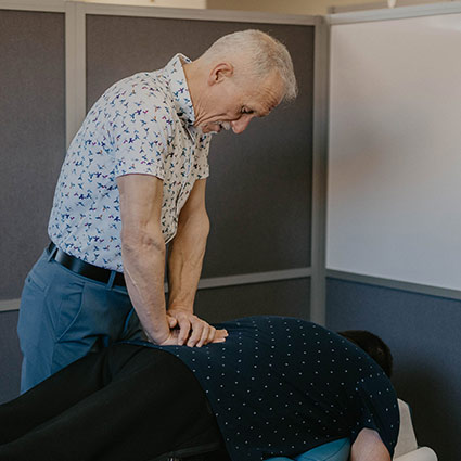 Dr Jim adjusting patients back