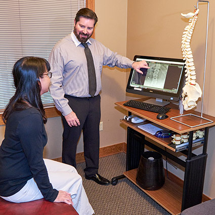 patient talking with chiropractor