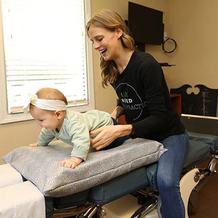Dr. Leah adjusting a baby