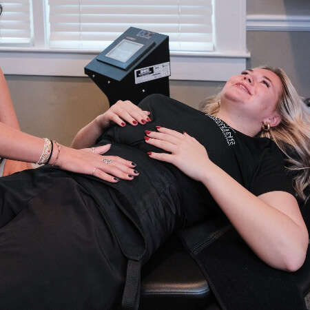 Canning Chiropractic and Laser Pain Solutions staff assisting patient with Spinal Decompression