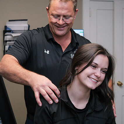 Lawrenceville chiropractor Dr Chris adjusting patients neck