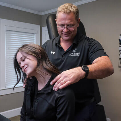 Dr Chris adjusting patients shoulder