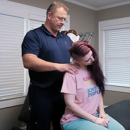 Dr Chris adjusting patients neck