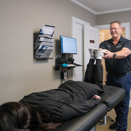 Chiropractor stretching patient's toes