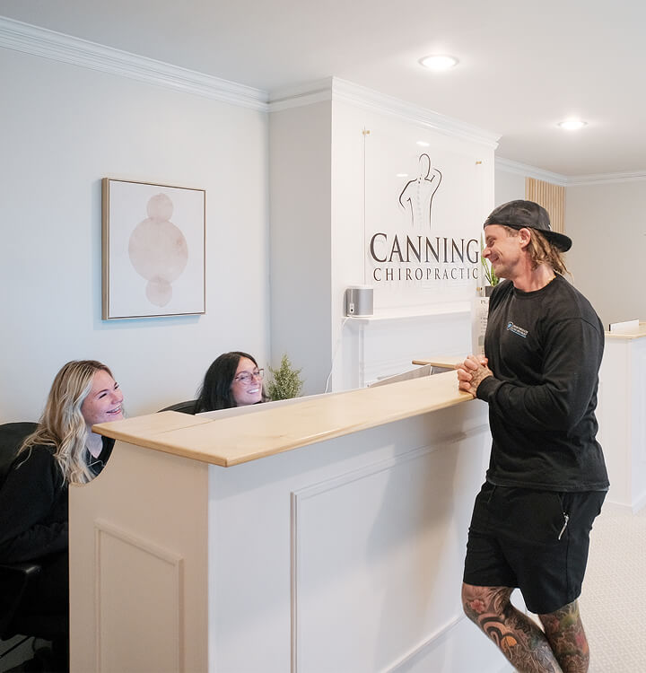 patient at the Canning Chiropractic and Laser Pain Solutions front desk