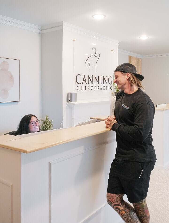 patient at the Canning Chiropractic and Laser Pain Solutions front desk