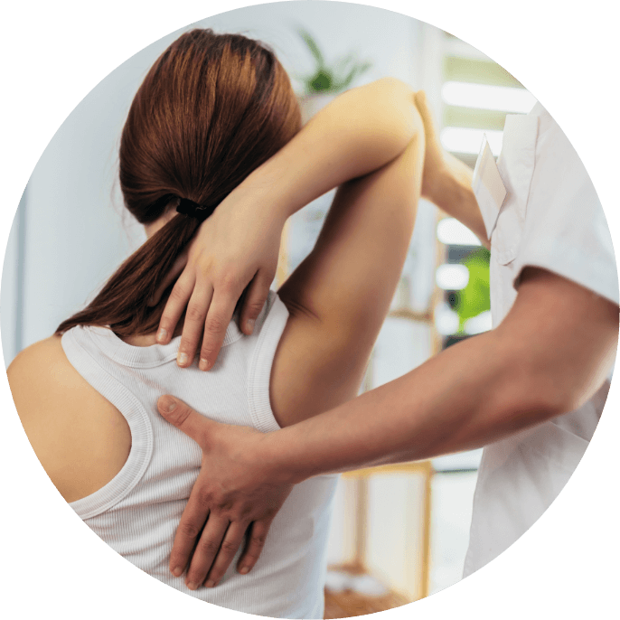 A chiropractor adjusting a woman's back