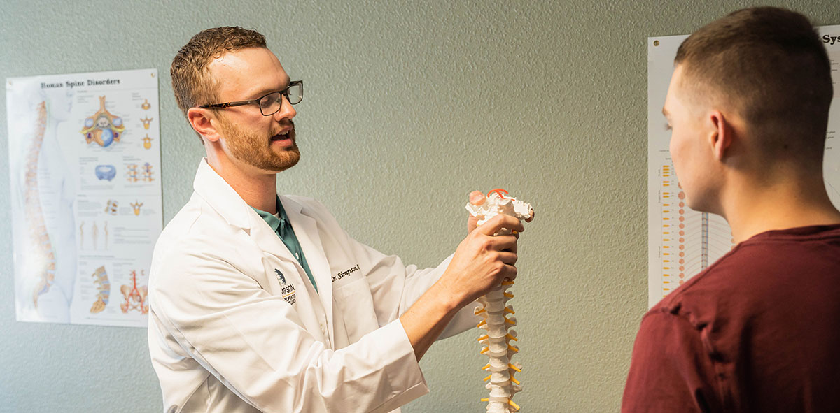 Dr. Simpson holding spine model