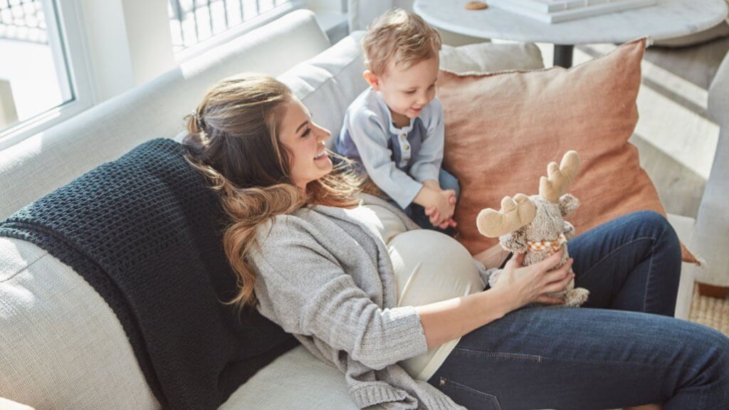 smiling pregnant mom with son