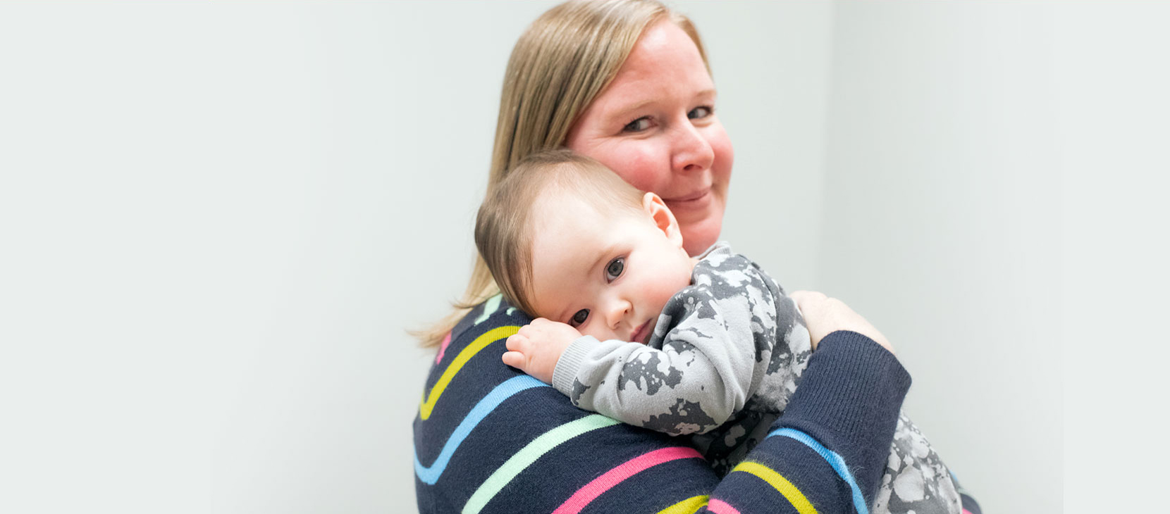 Dr. Lauren Mansolf holding a baby
