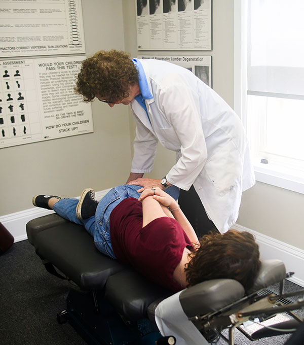 A doctor adjusting her patient