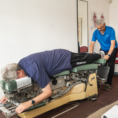 Chiropractor stretching patient's feet