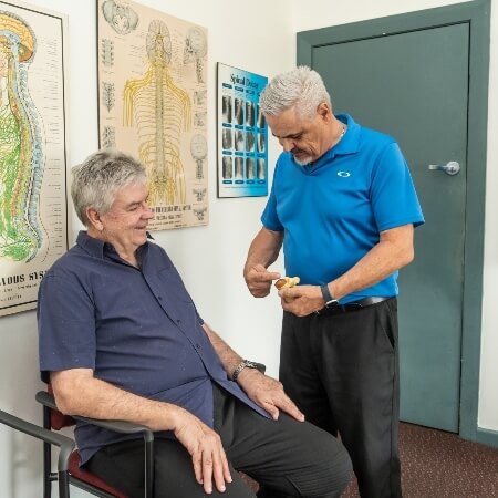 Chiropractor talking to patient