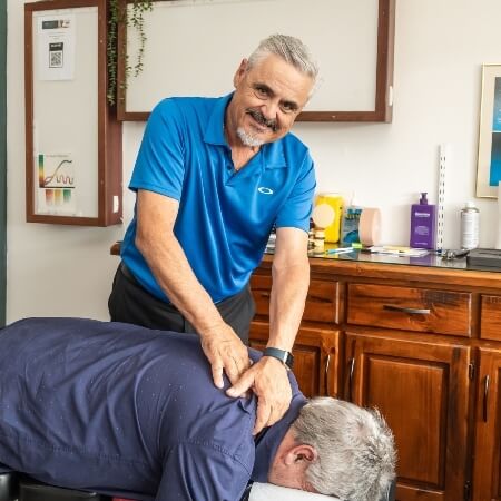 Chiropractor adjusting patient's upper-back