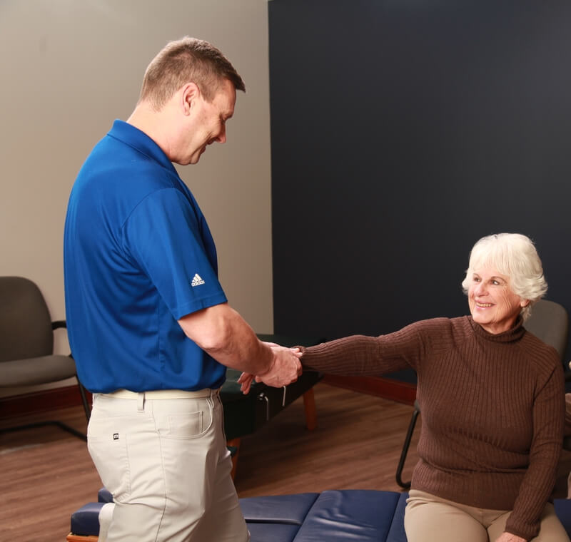 Chiropractor adjusting patients hand