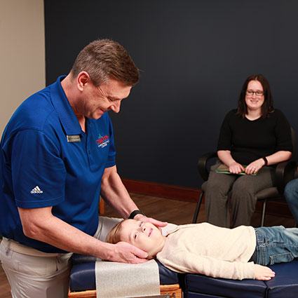 dr adjusting child patient