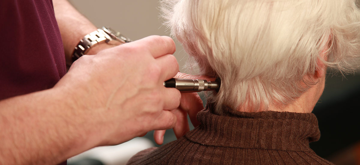 adjusting patients neck with tool