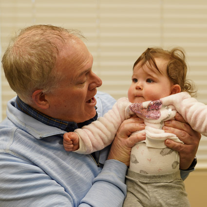 Dr. Brad Double smiling at baby