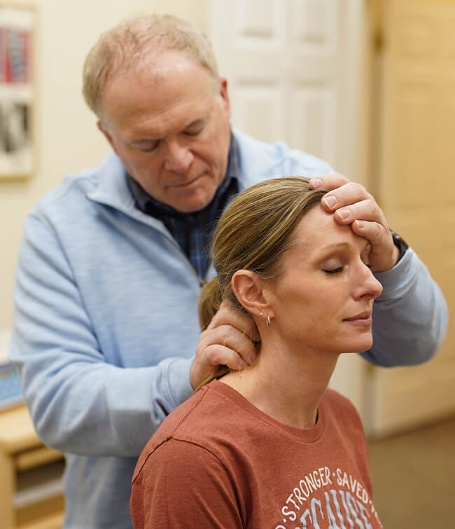 Dr. Brad adjusting patient neck