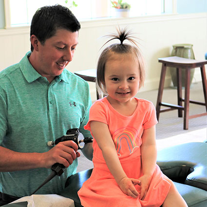 Doctor adjusting child