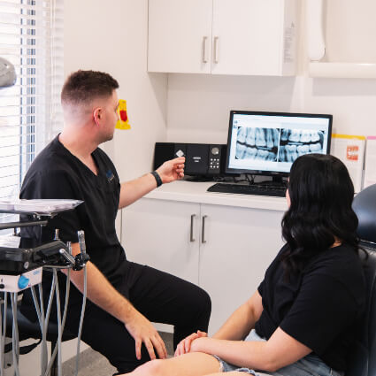 Dentist reviewing dental scan with patient