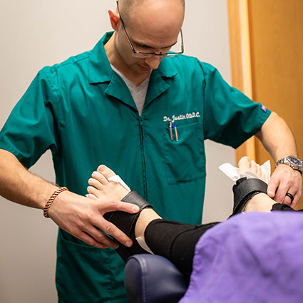 doctor touching persons foot