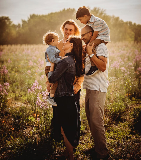 Dr. Justin Otto with his family standing in a meadow