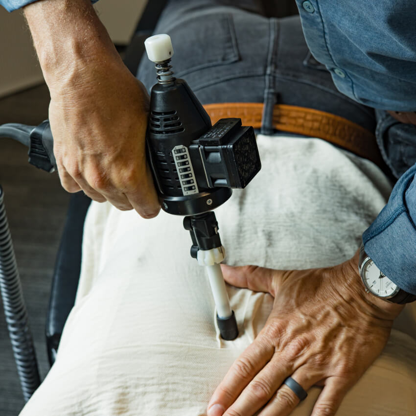 Arthostim tool being used on patients back