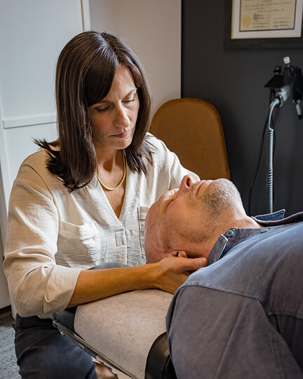 Franklin chiropractor Dr. Stacey adjusting patients neck
