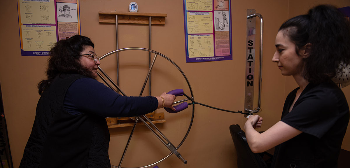Woman using wheel therapy