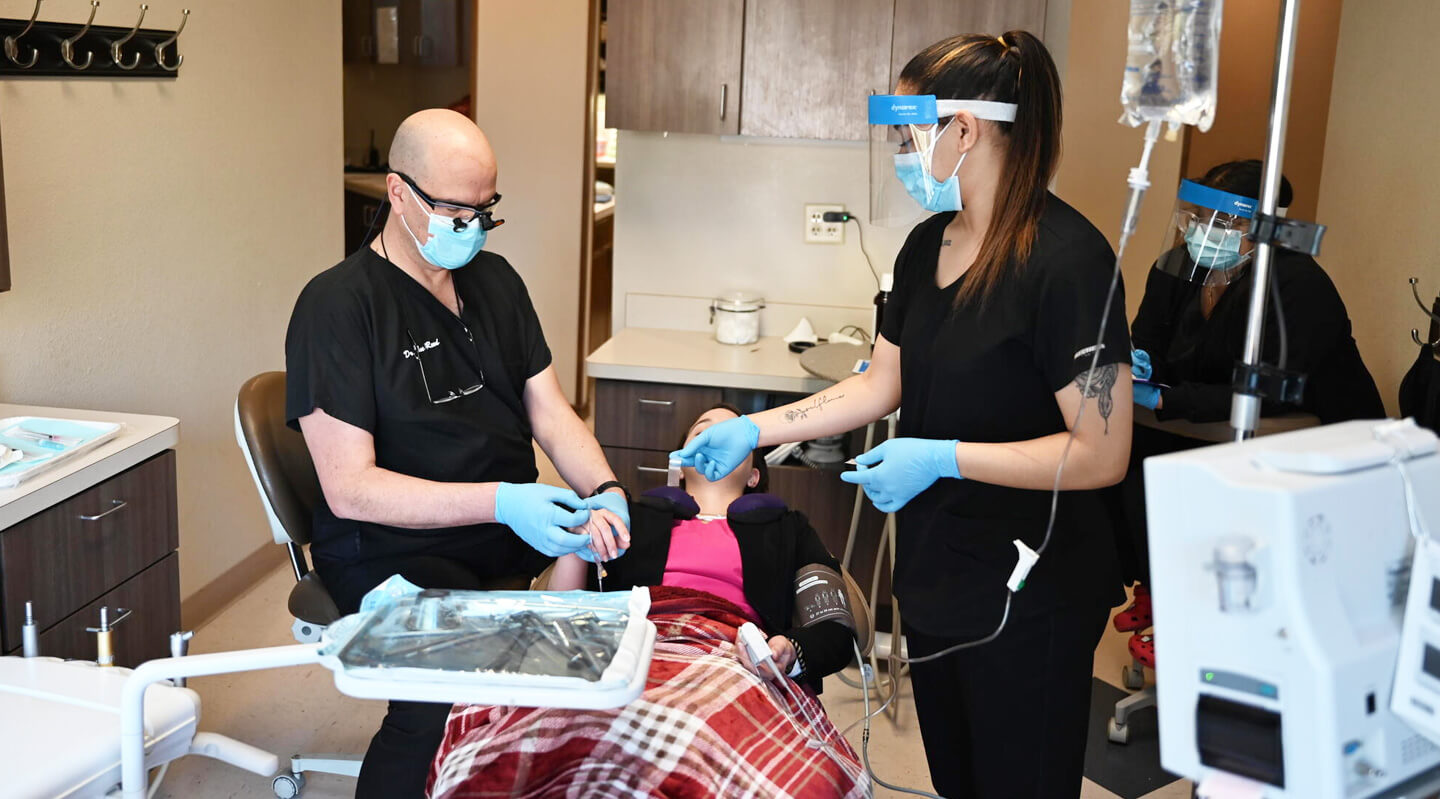 Dentists working with patient