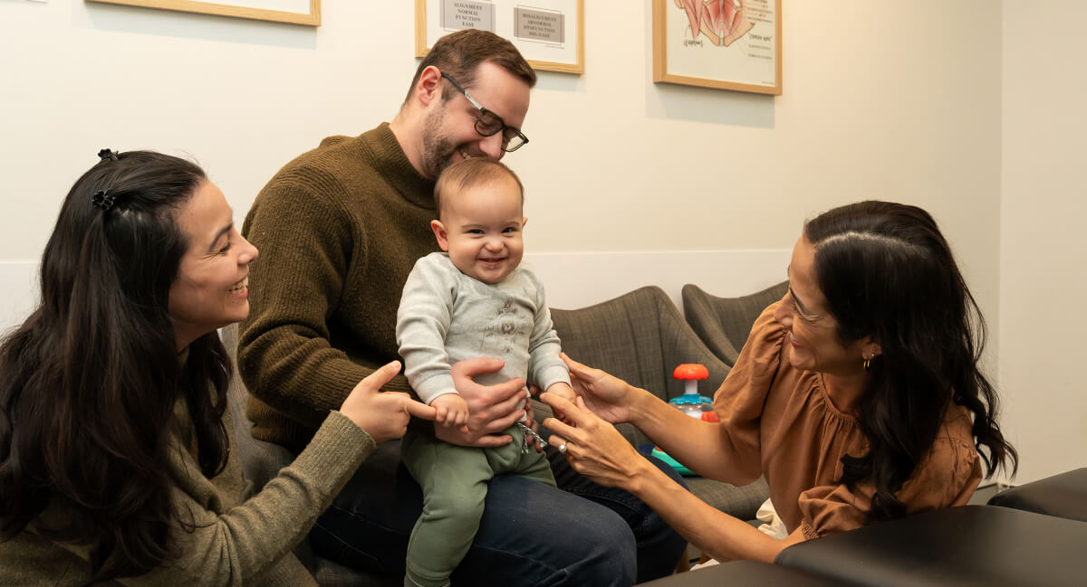 Infant patient and family in chiropractic consultation