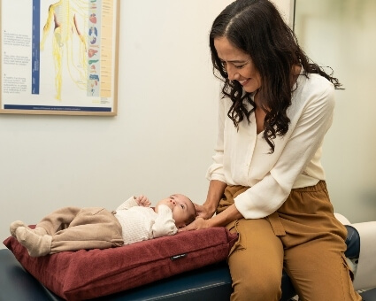 dr-kimberli-smiling-with-infant-patient