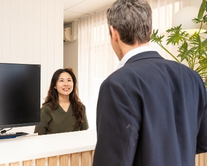 Receptionist greeting patient