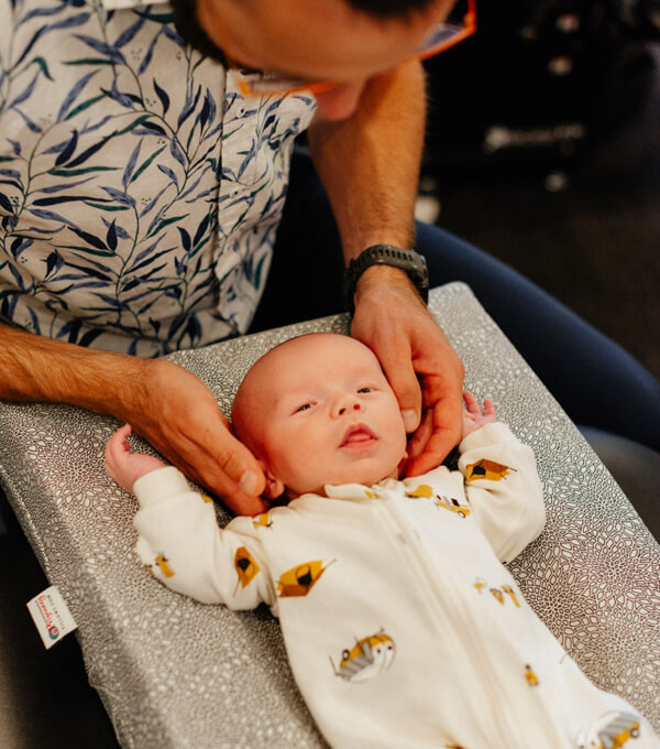 Dr Claire adjusting infant