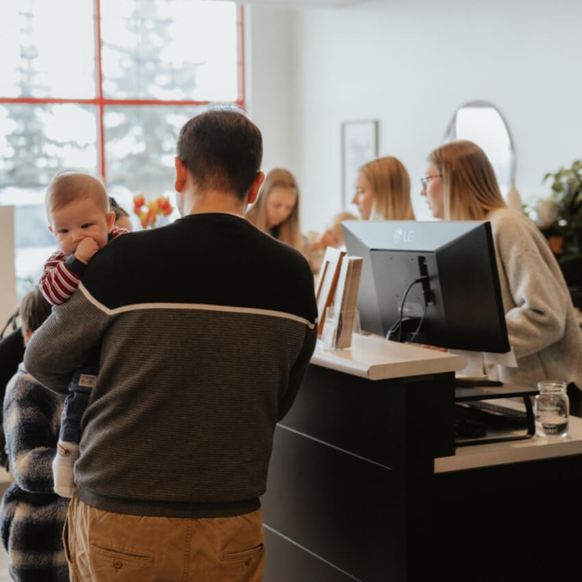 family at front desk