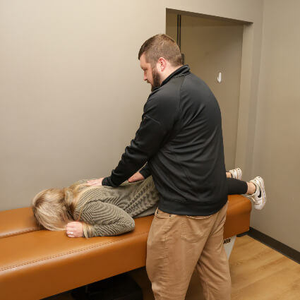 River Falls Chiropractor adjusting woman