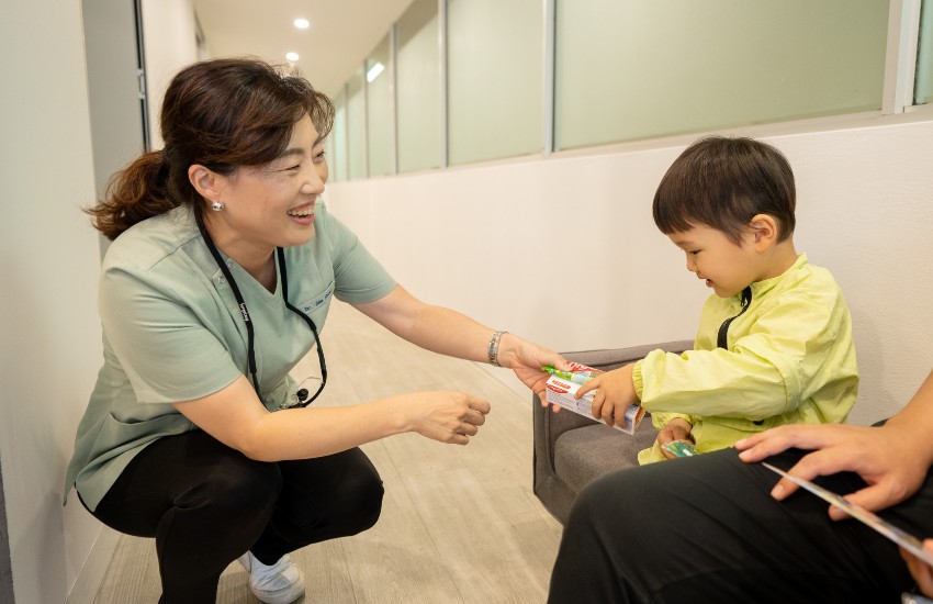 Dr Jae talking with child patient