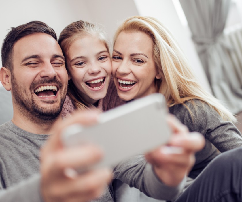 Family of three taking selfie