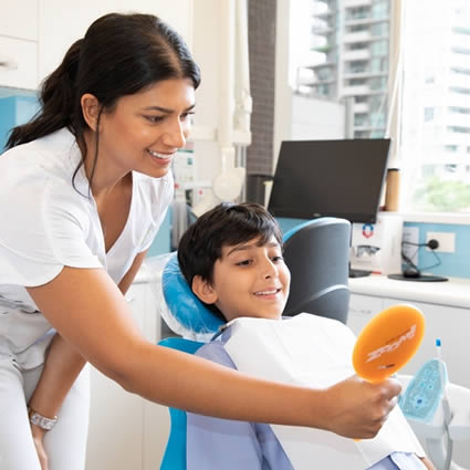 Dental assistant and child smiling