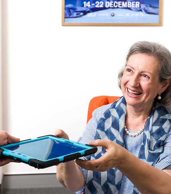 Patient receiving a tablet to fill out forms