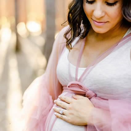 A pregnant woman with her hand on her belly