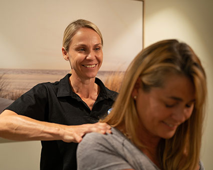 Woman massaging patient